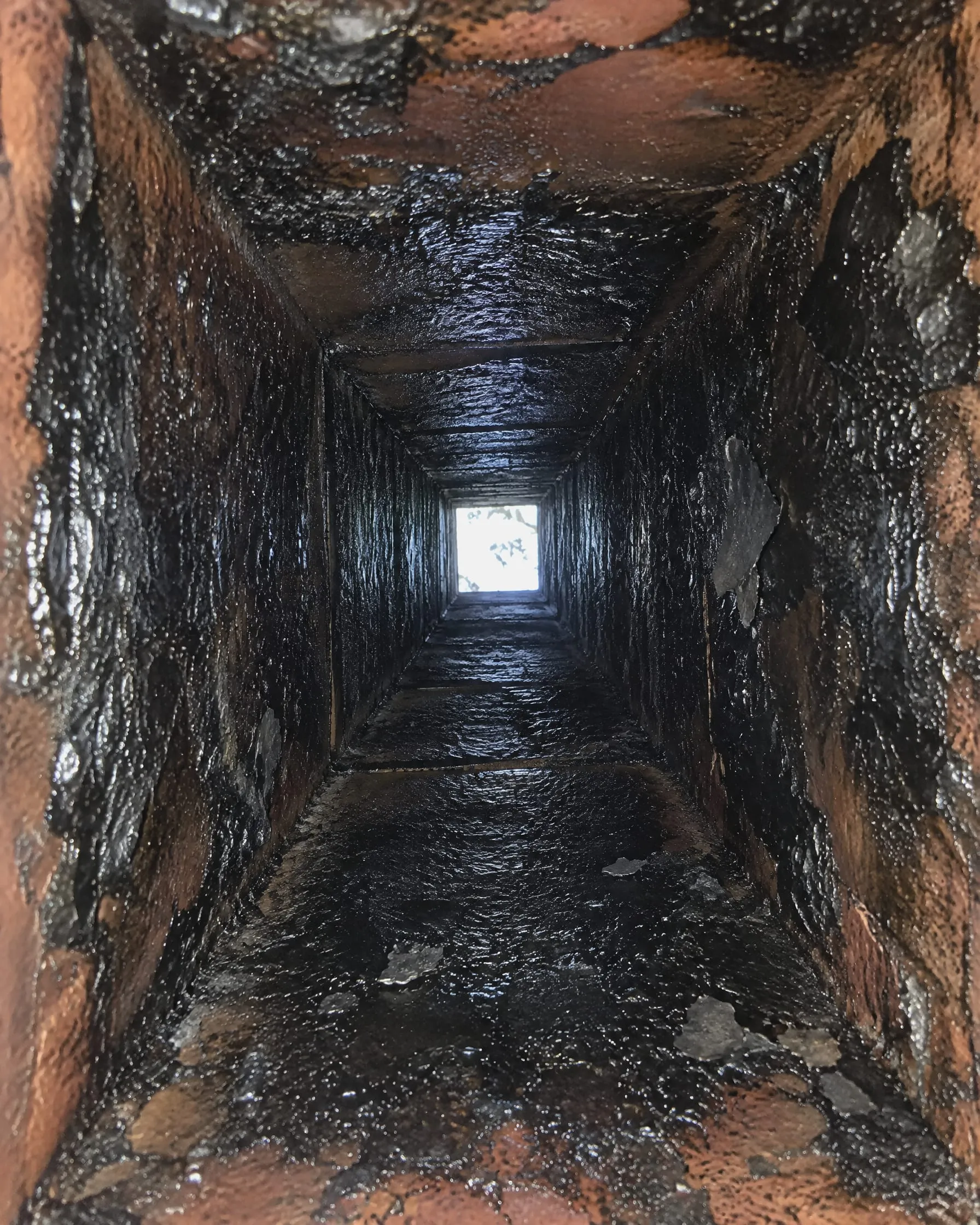 Example: chimney flue coated with glazed creosote before cleaning